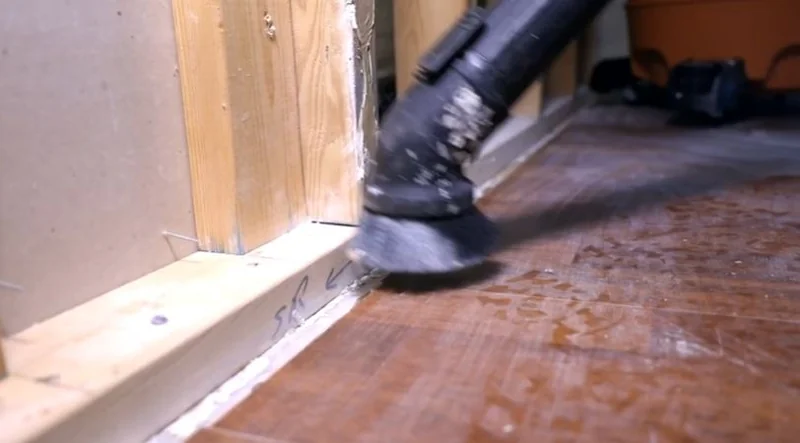 HEPA vacuuming wood framing and subfloor after moldy drywall was removed